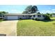 A charming single-story house with a well-manicured lawn, spacious driveway, and an American flag at 140 Whitehead Sw Rd, Oxford, GA 30054