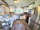 Well lit kitchen with stainless steel appliances, granite countertops, and white cabinetry at 140 Whitehead Sw Rd, Oxford, GA 30054