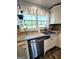 Kitchen features a stainless steel sink, granite countertops, and a bright window view at 140 Whitehead Sw Rd, Oxford, GA 30054