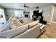Cozy living room boasts a stone fireplace, a ceiling fan, and a comfortable sectional sofa at 140 Whitehead Sw Rd, Oxford, GA 30054