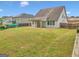 Spacious backyard with a covered patio, lawn, and privacy fence at 228 Madison Grace Ave, Mcdonough, GA 30252