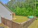 Fenced backyard featuring a well-maintained lawn and mature trees at 228 Madison Grace Ave, Mcdonough, GA 30252