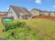 Expansive backyard with a covered patio and fully fenced perimeter at 228 Madison Grace Ave, Mcdonough, GA 30252
