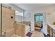 This bathroom features a soaking tub with tile surround, frameless shower, and open bedroom at 228 Madison Grace Ave, Mcdonough, GA 30252