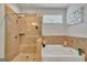 This bathroom features a soaking tub with tile surround and frameless shower at 228 Madison Grace Ave, Mcdonough, GA 30252