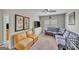 The bonus room features modern decor, with plush couches, a ceiling fan, and a large television at 228 Madison Grace Ave, Mcdonough, GA 30252