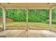 View from covered patio overlooking a spacious backyard and lush green trees at 228 Madison Grace Ave, Mcdonough, GA 30252