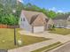 Lovely two-story home with brick and stone accents, featuring a convenient two-car garage at 228 Madison Grace Ave, Mcdonough, GA 30252