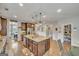 Open kitchen featuring a large island, stainless steel appliances, pantry, and eat-in area at 228 Madison Grace Ave, Mcdonough, GA 30252