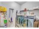 Laundry room featuring updated machines, shelving, and organization tools at 228 Madison Grace Ave, Mcdonough, GA 30252