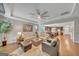 Spacious living room featuring hardwood floors, neutral paint, tray ceilings, and ample natural light at 228 Madison Grace Ave, Mcdonough, GA 30252