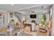 Open-concept living room with hardwood floors, a fireplace, a ceiling fan, and a staircase to the upper level at 228 Madison Grace Ave, Mcdonough, GA 30252