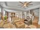 Open-concept living room with tray ceilings, hardwood floors, and seamless flow to kitchen and staircase at 228 Madison Grace Ave, Mcdonough, GA 30252