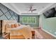 Stylish main bedroom features tray ceilings, an accent wall, and hardwood floors at 228 Madison Grace Ave, Mcdonough, GA 30252