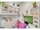 Bright home office featuring a unique decor with shelving, greenery, and accent lighting at 228 Madison Grace Ave, Mcdonough, GA 30252