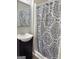 This bathroom features a vanity sink, mirror, and shower with patterned curtain at 260 Pinehurst Dr, Stockbridge, GA 30281