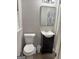 This bathroom has a toilet, a sink with vanity, and a mirror at 260 Pinehurst Dr, Stockbridge, GA 30281