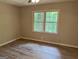 Bedroom with a large window and luxury vinyl plank flooring at 260 Pinehurst Dr, Stockbridge, GA 30281