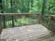 This deck has wood floors, a railing, and steps leading down into the yard at 260 Pinehurst Dr, Stockbridge, GA 30281