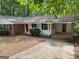 Charming single-story home featuring brick accents, a covered entryway, and mature landscaping at 260 Pinehurst Dr, Stockbridge, GA 30281