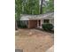 Charming single-story home featuring brick accents, a covered entryway, and mature landscaping at 260 Pinehurst Dr, Stockbridge, GA 30281