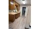 Functional kitchen features wooden cabinets, durable laminate countertops, and modern laminate flooring at 260 Pinehurst Dr, Stockbridge, GA 30281