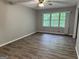 Living room with hardwood floors, neutral paint, ceiling fan, and a large window at 260 Pinehurst Dr, Stockbridge, GA 30281
