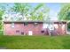 Brick house backyard with green grass and a stairway leading to an entrance at 3903 Rex Rd, Rex, GA 30273