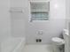 Bright bathroom features a tiled shower-tub and hexagon tile floor at 3903 Rex Rd, Rex, GA 30273