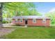Charming single-story brick home with a well-maintained lawn and mature trees at 3903 Rex Rd, Rex, GA 30273