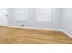 Bright living area featuring refinished hardwood floors, neutral colors, and new windows at 3903 Rex Rd, Rex, GA 30273