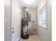 Utility room with water heater and window providing natural light at 3903 Rex Rd, Rex, GA 30273