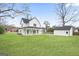 Wide shot of the property showing a large yard, detached garage, and back exterior of the home at 61 Main St, Moreland, GA 30259