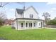 Back exterior of a two-story home featuring a covered patio and large manicured backyard at 61 Main St, Moreland, GA 30259