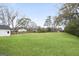 Expansive backyard featuring a lush, well-maintained lawn and mature trees, perfect for outdoor activities at 61 Main St, Moreland, GA 30259