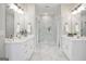 Bright primary bathroom featuring double vanities, a glass shower, and stunning marble flooring at 61 Main St, Moreland, GA 30259