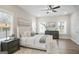 Bright bedroom featuring a plush bed, stylish nightstands, modern dresser, and a ceiling fan at 61 Main St, Moreland, GA 30259
