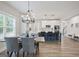 Dining area featuring modern lighting and an open view to the kitchen with island at 61 Main St, Moreland, GA 30259