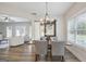 Open dining room with table set for four, natural light, and a view of the living room at 61 Main St, Moreland, GA 30259