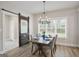 Dining room with a sliding barn door and a view to the laundry room at 61 Main St, Moreland, GA 30259