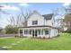 Charming two-story home featuring a covered front porch, black shutters, and a well-maintained lawn at 61 Main St, Moreland, GA 30259