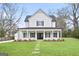 Charming two-story home with a welcoming front porch and meticulously manicured lawn at 61 Main St, Moreland, GA 30259
