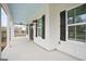 Spacious front porch with a light blue ceiling and black shutter accents at 61 Main St, Moreland, GA 30259