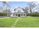 Beautiful two-story home with manicured lawn, stepping stone path, and covered front porch with columns at 61 Main St, Moreland, GA 30259