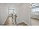 Hallway with hardwood floors, wood railings, and natural light at 61 Main St, Moreland, GA 30259