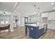 Open kitchen layout featuring a large island with seating and modern stainless steel appliances at 61 Main St, Moreland, GA 30259