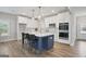 Modern kitchen features a large island, stainless steel appliances, and sleek white cabinetry at 61 Main St, Moreland, GA 30259