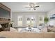 Cozy living room featuring a brick fireplace, white shiplap, and double doors to the backyard at 61 Main St, Moreland, GA 30259