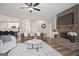 Living room with a fireplace and an open view to the kitchen with bar seating at 61 Main St, Moreland, GA 30259