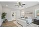 Serene main bedroom with a ceiling fan, plush bedding, and an ensuite bathroom at 61 Main St, Moreland, GA 30259